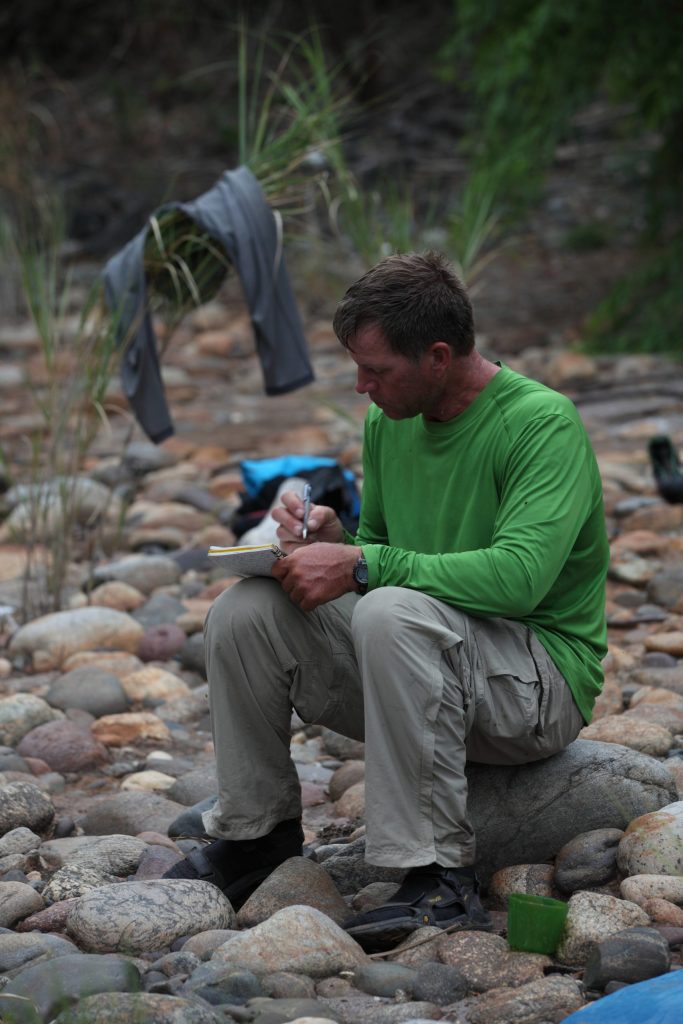 West Hansen Taking Notes River Shoreline