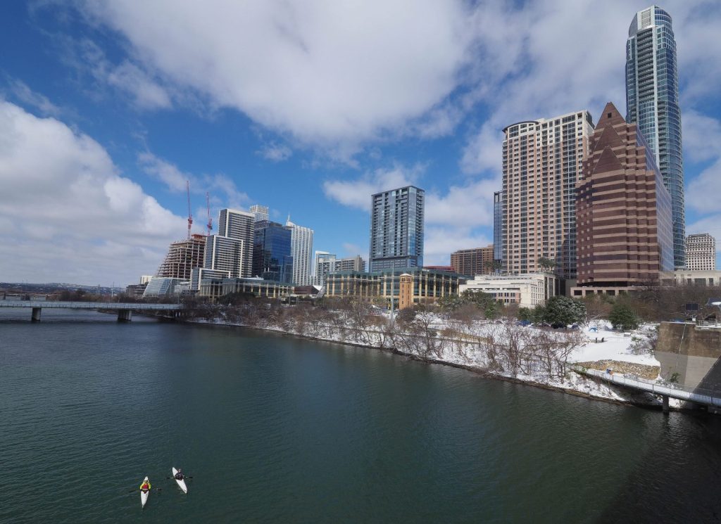 West Hansen and Jimmy Harvey paddle Lady Bird Lake on a rare snowy day in Austin, Texas. Pam LeBlanc photo